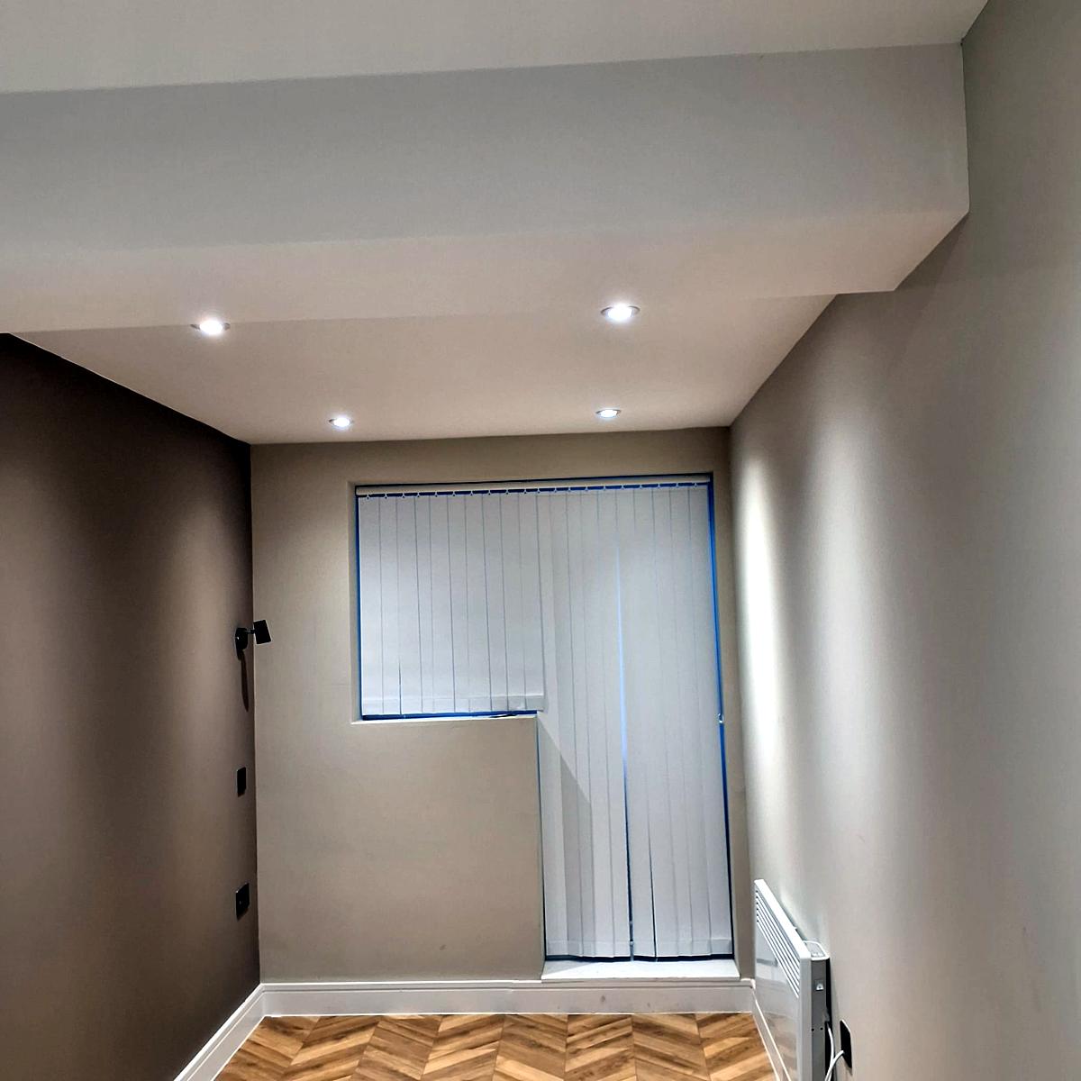 White vertical blinds on an L-shaped window and door opening